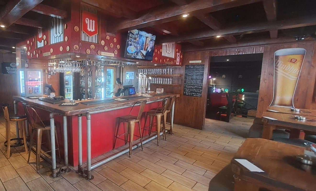 Little Britain Pub bar interior with warm wood panelling